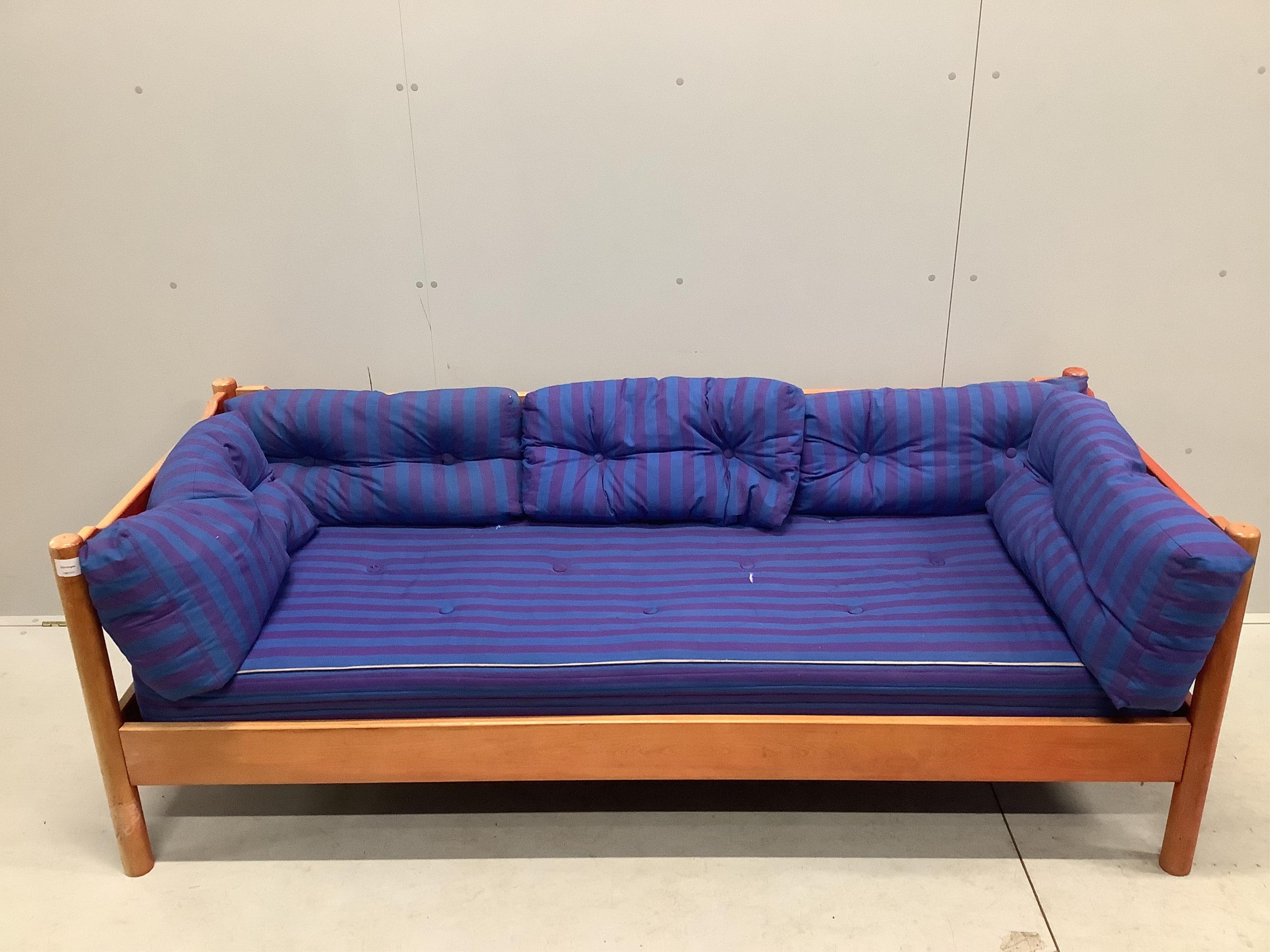 An early Habitat Magistretti style red stained beech settee, width 198cm, depth 84cm, height 69cm and a matching elbow chair. Condition - poor to fair